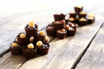 Composition of different chocolate candies on wooden background, close up
