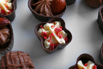 Composition of chocolate candies on white background, close up