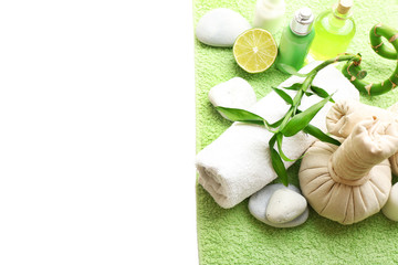 Obraz na płótnie Canvas Relaxing spa set on green soft towel which lying on white background