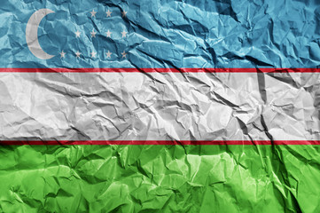 Uzbekistan flag painted on crumpled paper background