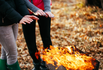 lesbian girls are heated by the fire.