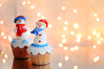 Christmas cupcakes with lights on background