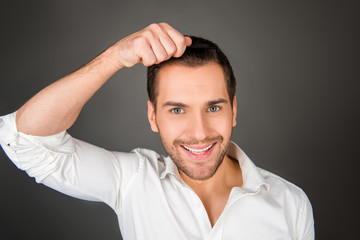 Smiling young man making a hairdress