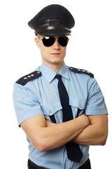Portrait of young policeman in uniform with sunglasses