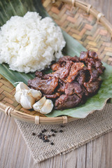 Deep fried marinated beef Thai Style on wood basket and wood bac