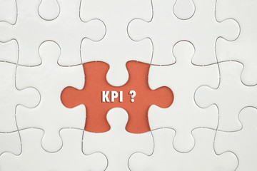 Fototapeta premium Jigsaw puzzle on color paper background with a word KPI ?