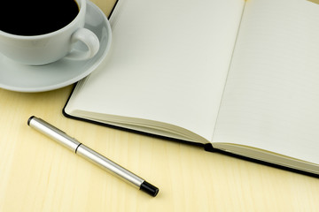 Office table with pen, notepad, cup of coffee. Top View
