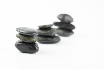 Black pebble on white background isolated