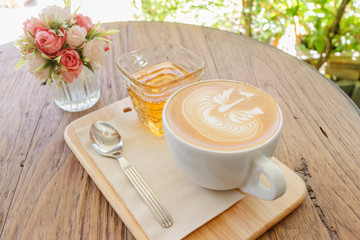 Cup of coffee latte art on wood table, selective focus