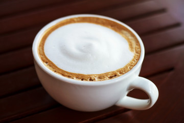 Coffee cup top view on wooden table background