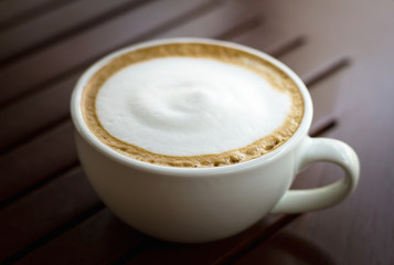 Coffee cup top view on wooden table background
