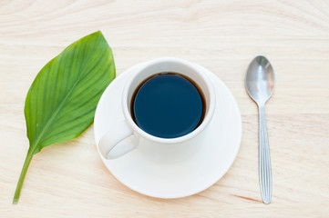 Hot black coffee on wood floor