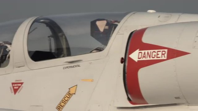 Pan across details of an L-39 Albatross jet trainer, parked in early morning.  Recorded in 4K, ultra high definition.