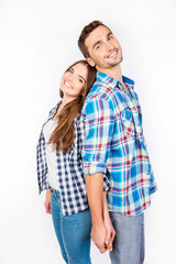 Portrait of young people standing back-toback holding hand in ha