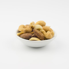 Bowl with nuts on a white background