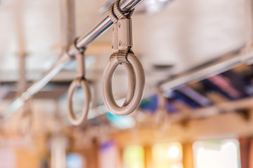Handles on ceiling for standing passenger inside a bus