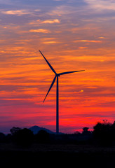 Eco power in wind turbine farm with sunset