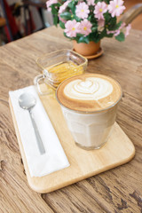 Fototapeta na wymiar Cup of coffee latte art with tea on wood table