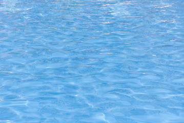 blue swimming pool with sunny reflections