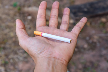 Smoking cigarette with hand closeup in outdoor