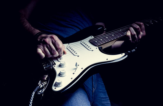 Young man playing electric guitar. Music, instrument education, entertainment, rock star, music concert and learning concept