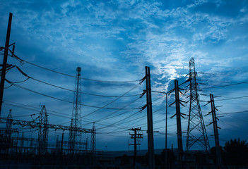 Electricity pylon,Electricity tower station with cloudy and sun over blue sky