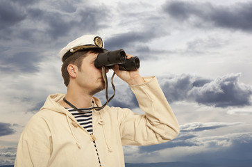 Captain looks through a binoculars