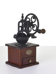 Old wooden coffee grinder with handle on white