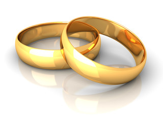 couple of gold wedding rings on white background