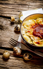 Prepared ravioli with tomato sauce in a Cup.