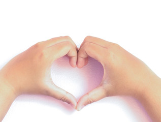 little hands shaping a heart symbol on pink background