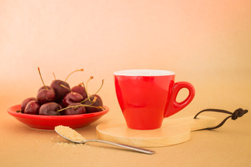Beautiful breakfast of red coffee cup and cherries