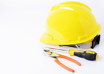 Helmet with screwdriver and pliers on white backgrounds