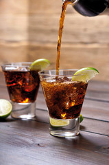Pour the rum and cola cuba libre with lime, ice