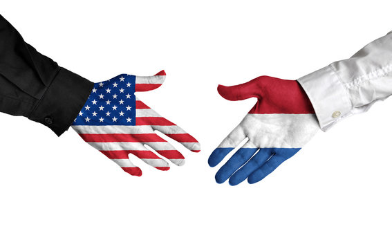 United States and Netherlands leaders shaking hands on a deal agreement