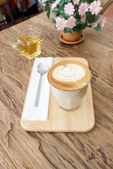Fototapeta na wymiar Cup of coffee latte art on wood table