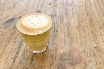 Cup of coffee latte art on wood table