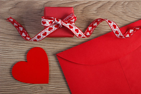Wrapped gift, red heart and love letter for Valentines Day, copy space for text