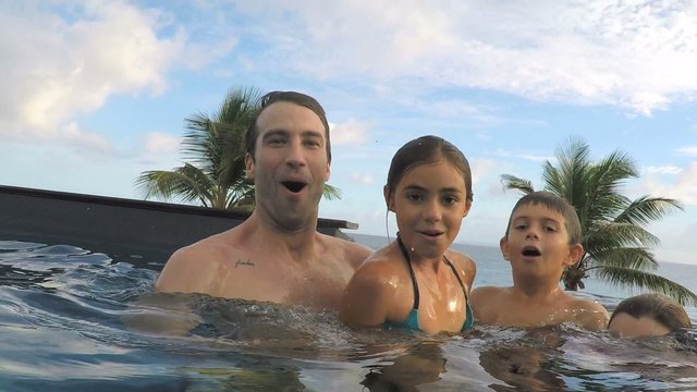 Parents with chilldren swimming underwater 