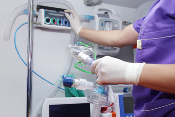 Closeup  oxygen mask in hands nurse