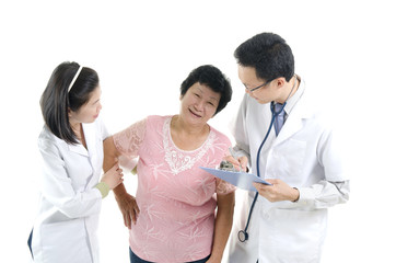 Fototapeta premium Image of a doctor and his nurse checking up a senior patient in