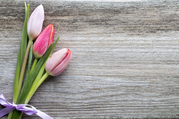 Tulips on the wooden background.