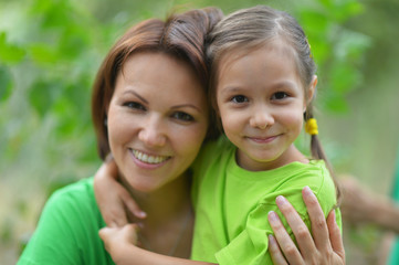 Girl with  mother in summer park