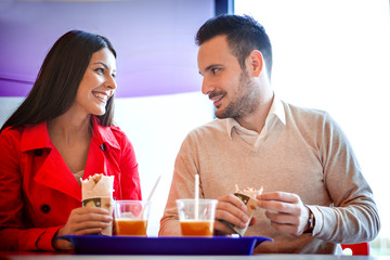 Couple eating in fast food restaurant