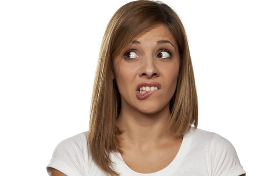 scared and worried young woman on a white background
