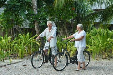 elderly couple rest with bicycles