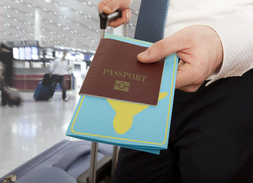 Businessman handing passport and ticket