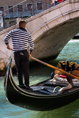 Gondolier in Venice Near Marble Bridge in Venice, Italy