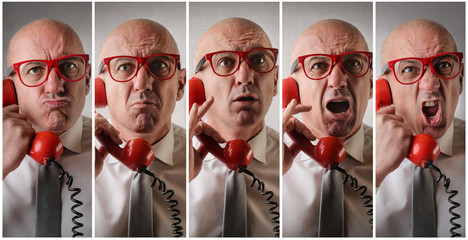 Angry man answering the phone