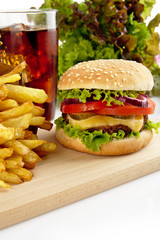 Menu of cheeseburger,french fries,glass of cola on wooden plate
